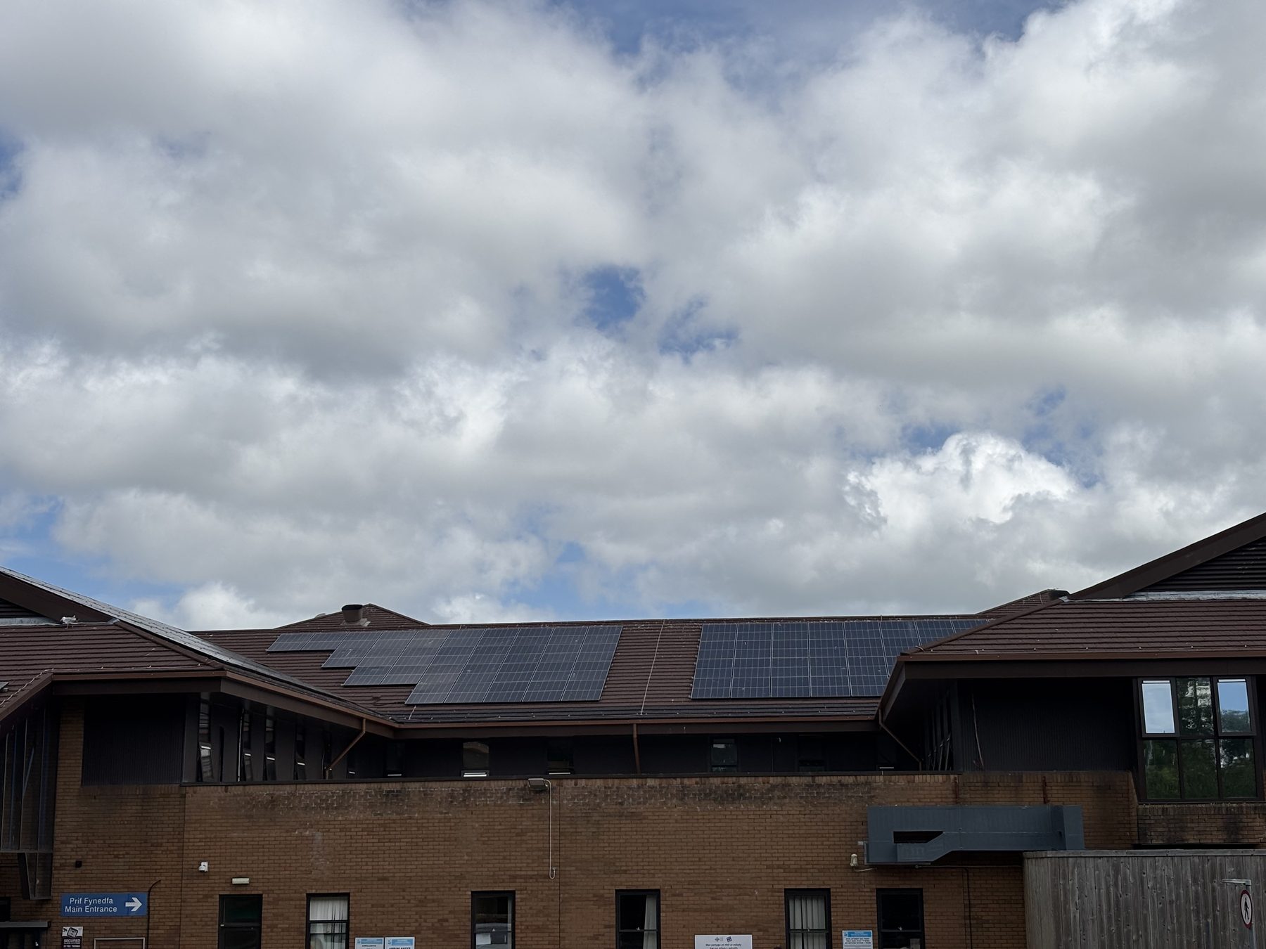 Princess of Wales Hospital main entrance with rooftop solar panels, Bridgend