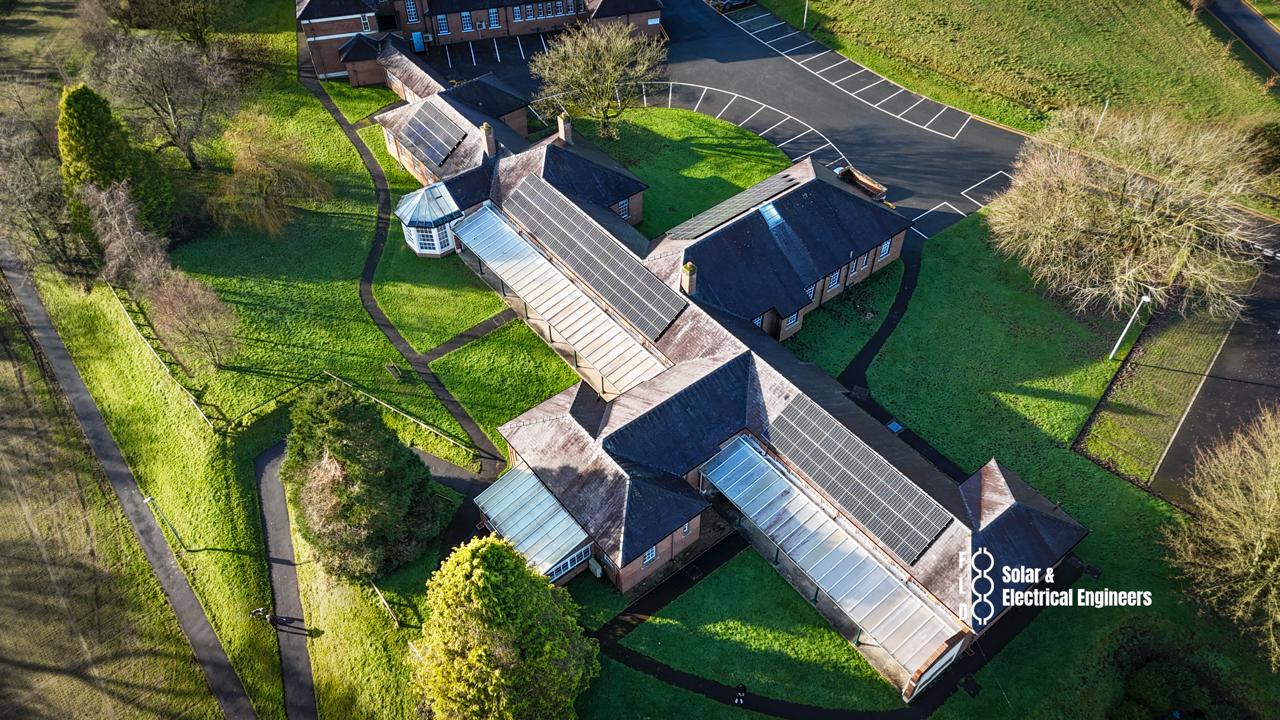 Solar panels installed across pitched tiled roof at Parc Dewi Sant