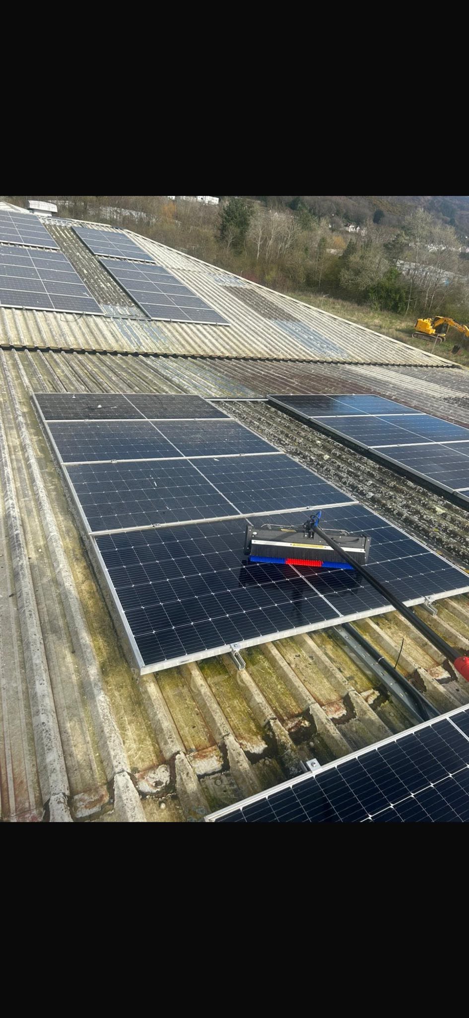 FLD cleaning a commercial solar array with a reach-and-wash purified-water pole, South Wales
